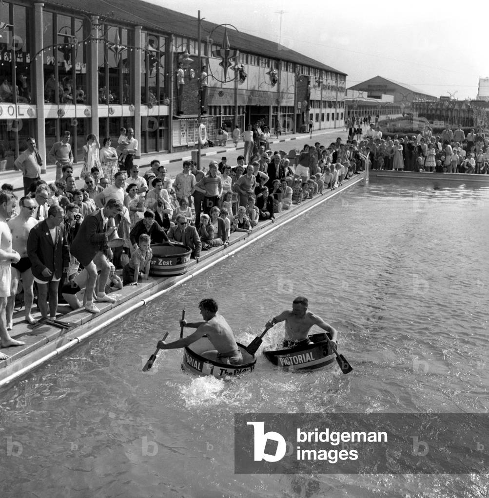 Tub racing at the Brighton Ocean Hotel Lido. The tub racing competition was sponsored by the Sunday Pictoral newspaper. Foul play is a foot as one of the competitors tries to sink a rival. June 1960