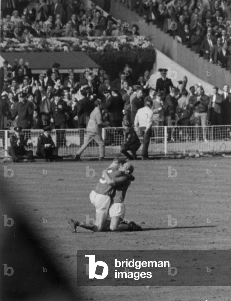 World Cup Final at Wembley Stadium. England 4 v West Germany 2 after extra time. England brothers Jack and Bobby Charlton sink to their knees as they celebrate victory at the final whistle. 30th July 1966 (photo)