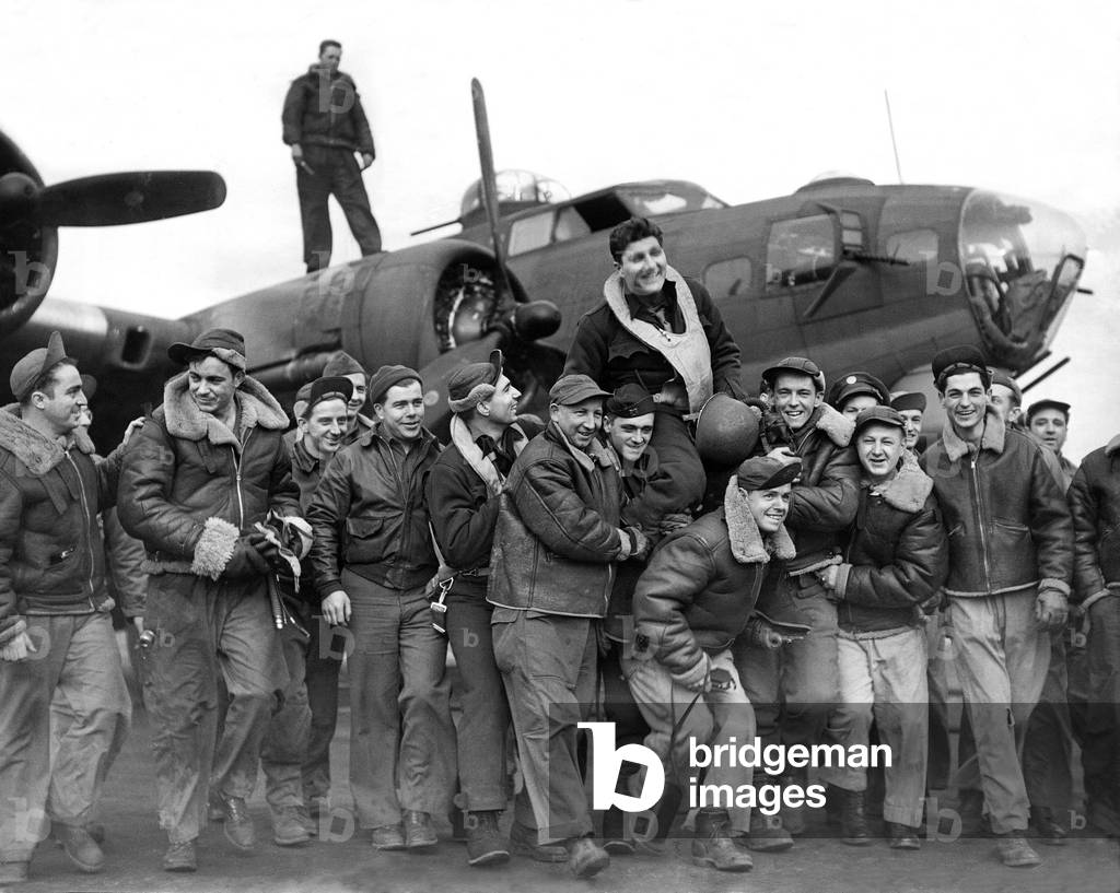 Captain Bender of California celebrates with crew members of the US Eighth Air Force after finishing his 25th operation, 21st March 1944 (b/w photo)