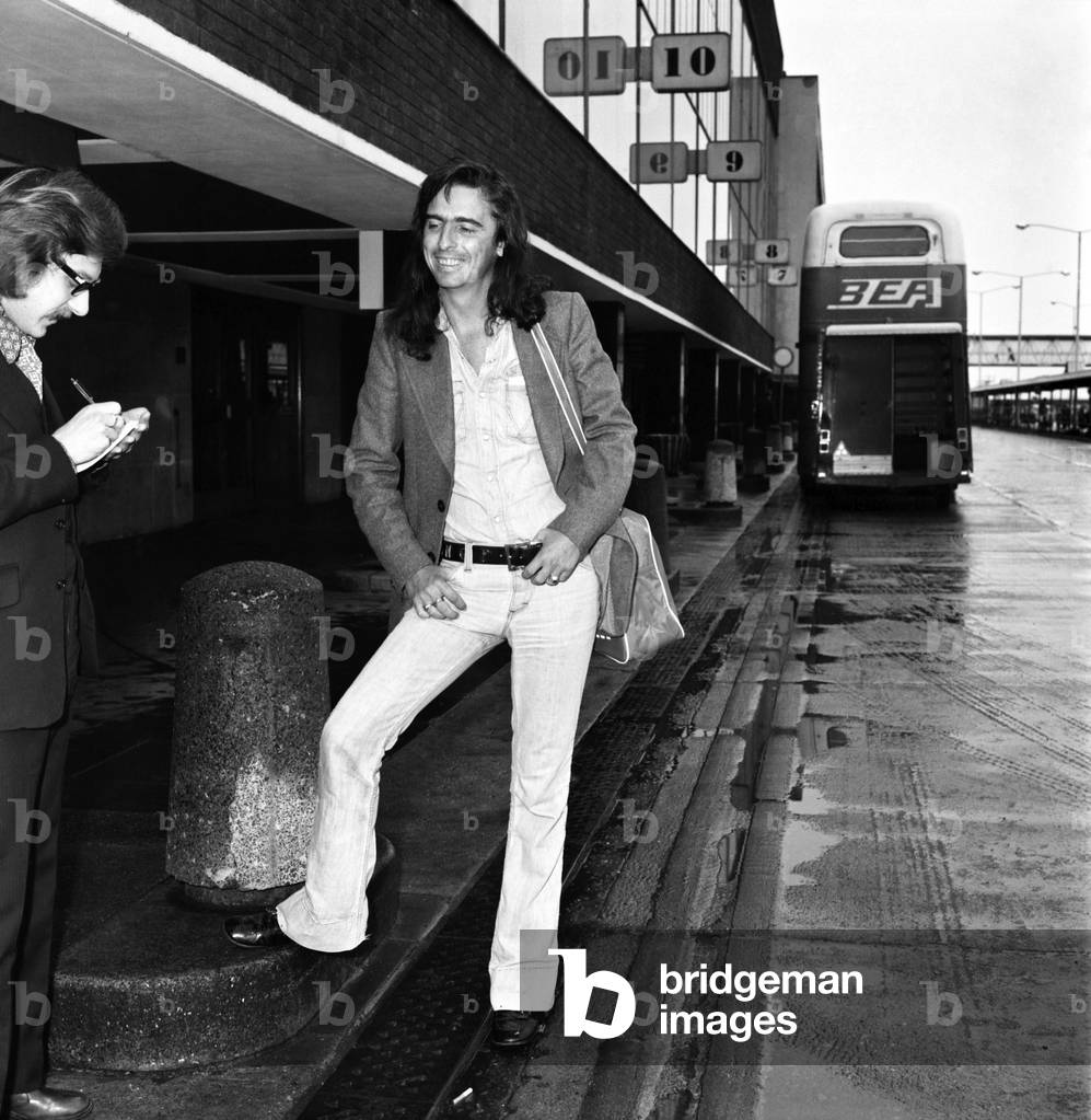 American rock singer Alice Cooper arrives in London ahead of his tour, 15th March 1974 (b/w photo)