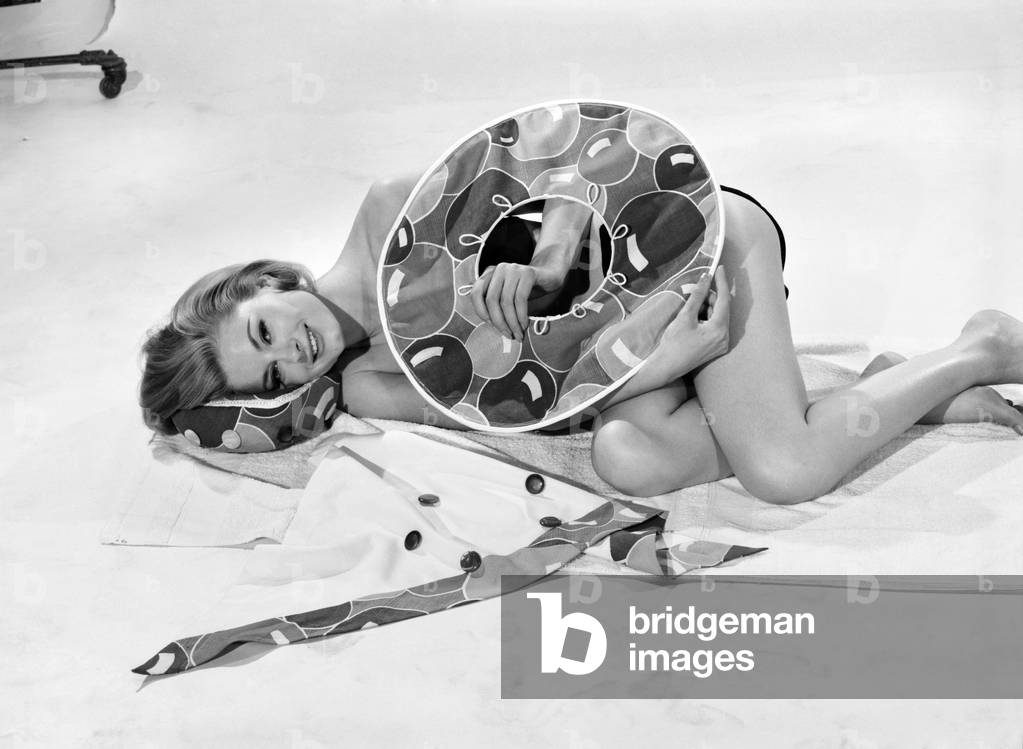 Model Margaret Lorraine wearing beach cushion hat, August 1962 (b/w photo)