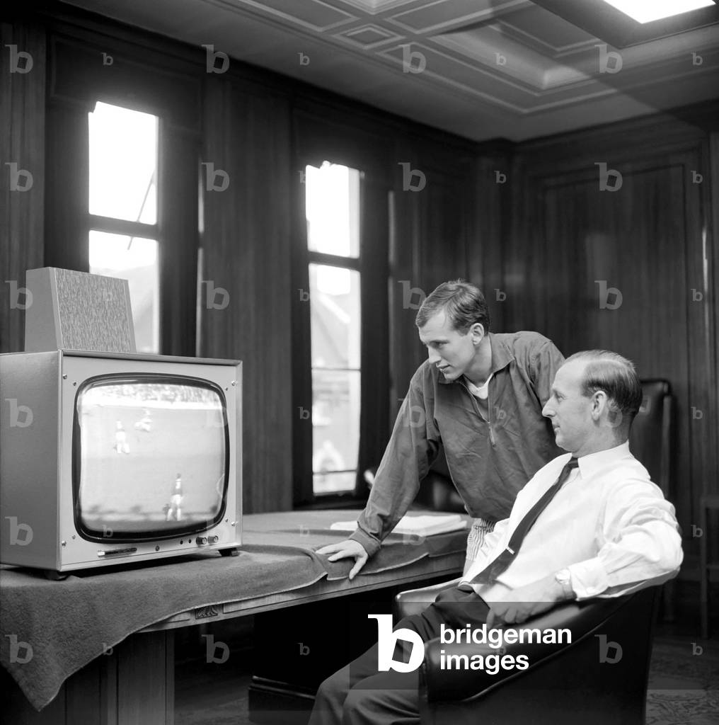 Arsenal Manager Bertie Mee and new signing Bob McNab watch T. V. October 1966 W9209-001 (photo)