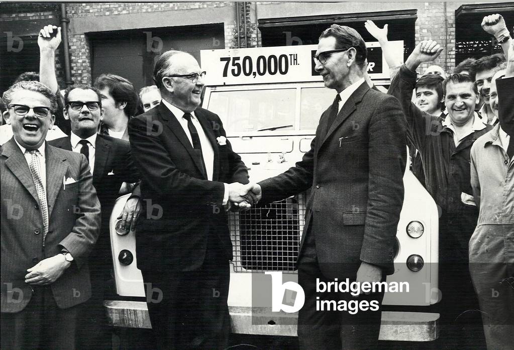 Sir George Farmer congratulating production manager Mr James Lawrence as the 750,000th Land Rover came off the assembly line today, 1st July 1971 (b/w photo)