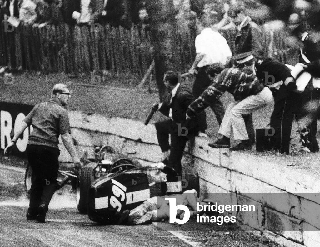 Mike Walker lies beside his wrecked Formula 3 car 1967
