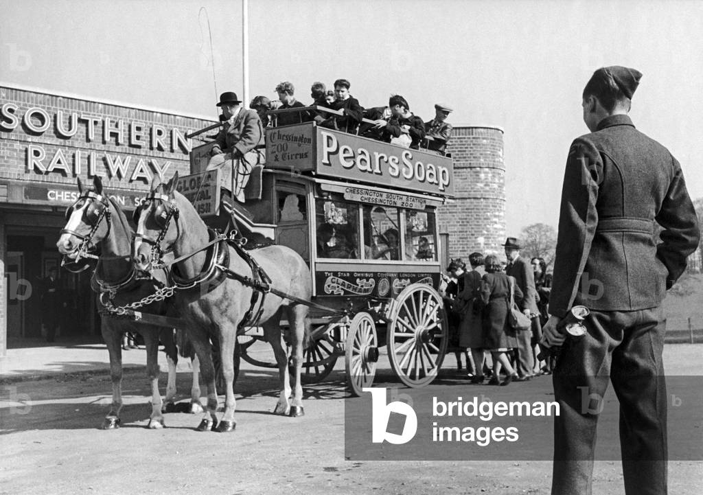 An old London Horse Bus which used to operate in Brixton is given a new lease of life transporting passengers from Chessington South Station to the zoo. 27th March 1944 (b/w photo)