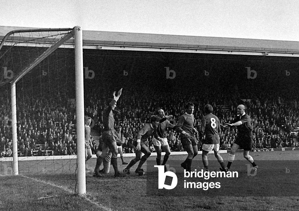 Manchester United's John Fitzpatrick surrounded by angry Liverpool players after a challenge on goalkeeper Tommy Lawrence during the two team's match at AnfieldOctober 1968 (photo)