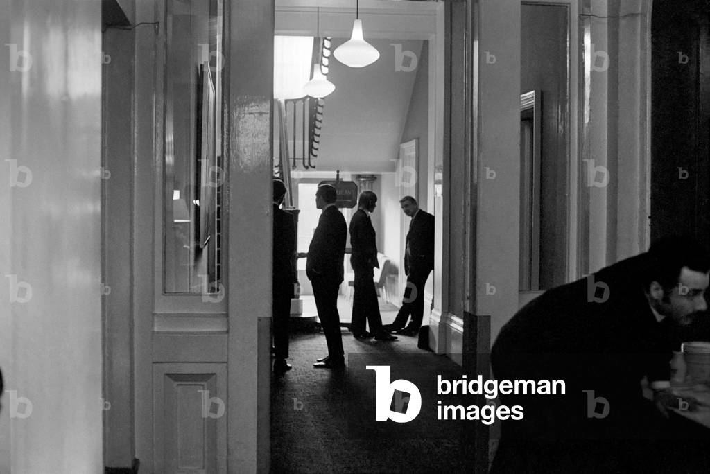 The FA disciplinary commission met in the Midland Hotel, Derby, to consider the four bookings of Manchester United's John Fitzpatrick. Mr. Cliff Lloyd (right) talking to Fitzpatrick, in the hallway, outside room 44 where the commission are sitting. Wilf McGuinnes (is 3rd from right). November 1969 (photo)