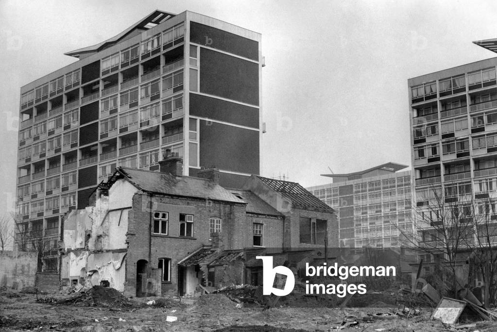 A contrast between old and new buildings in Coventry. Modern blocks of flats tower over partly-demolished houses in Queen's Street, Hillfields, Coventry.
23rd November 1966