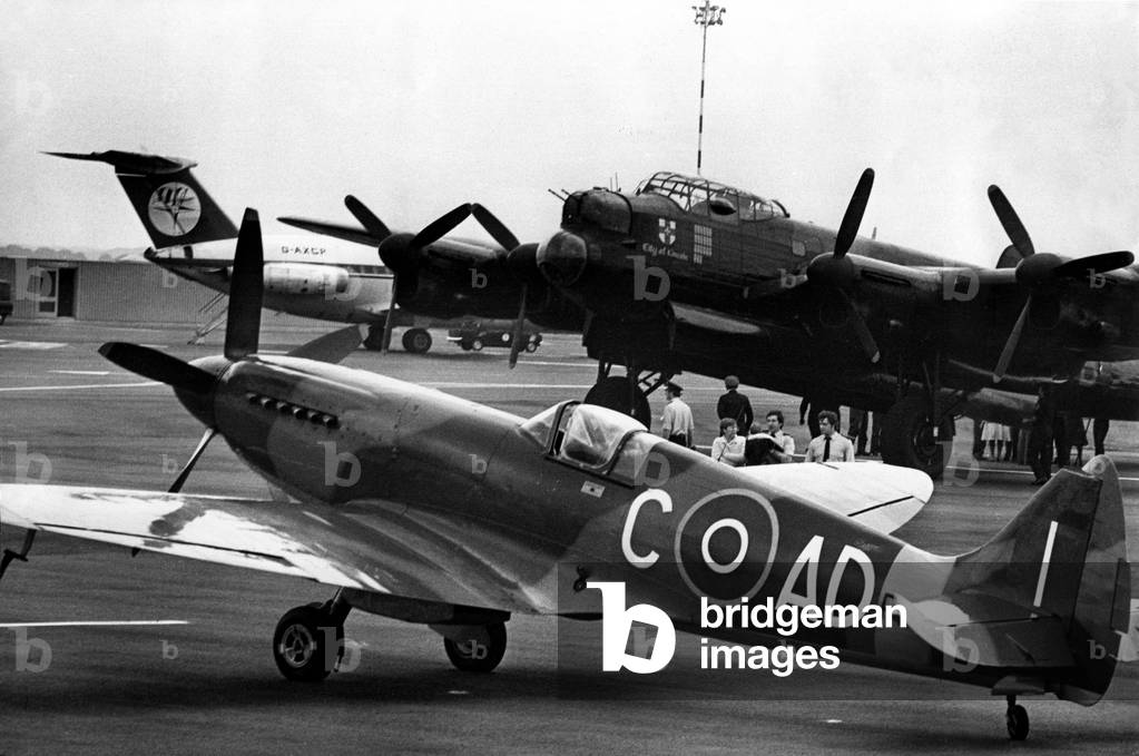 A Supermarine Spitfire Mk PRXIX and Avro Lancaster of the Battle of Britain Memorial Flight at Newcastle Airport. Part of the Lancaster crew, to arrive from RAF Coningsby, was RAF master engineer, Derek Butcher, 54, of Jackson Avenue, Ponteland. The aircraft were to take part in the Tyneside Military Tattoo, giving a 15 minute display at South Shields. 25/08/1979 (b/w photo)