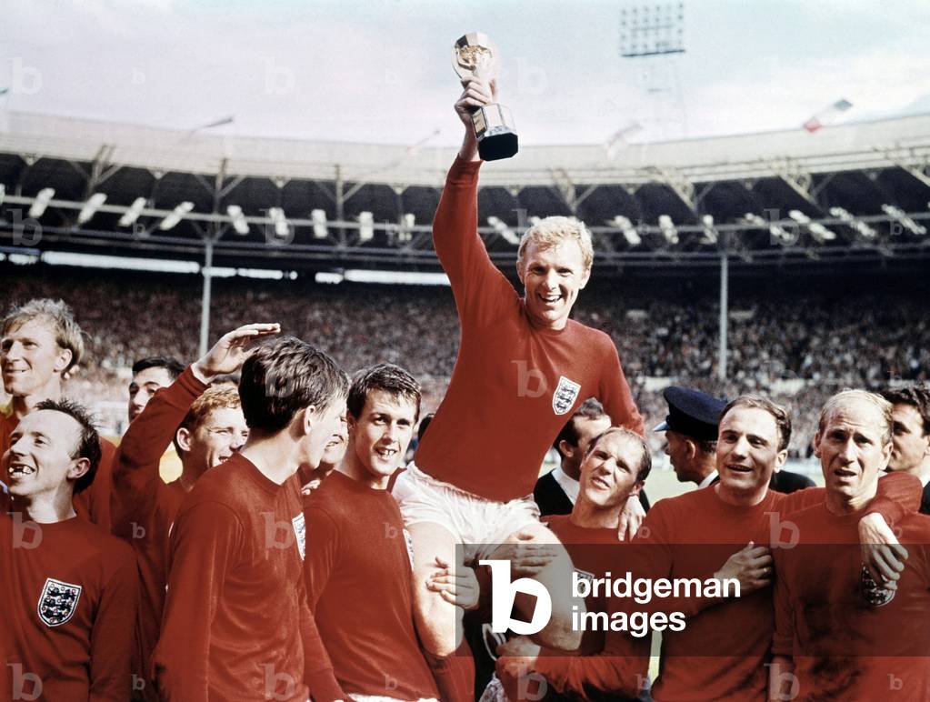 1966 World Cup Final at Wembley Stadium July 1966 England 4 v West Germany 2 Captain Bobby Moore holds aloft the Jules Rimet trophy as he sits on the shoulders of his teammates They are L-R: Jack Charlton, Nobby Stiles, Gordon Banks, Alan Ball, Martin Peters, Geoff Hurst, Ray Wilson, George Cohen and Bobby Charlton (photo)