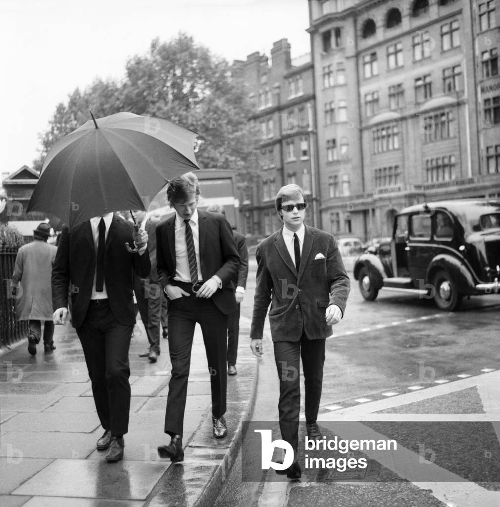 Rolling Stones: manager Andrew Loog Oldham and his chauffeur Reg Stiles (sunglasses) appeared at Marylebone Magistrates Court today on charges of common assault and wilful damagein June 1965.
