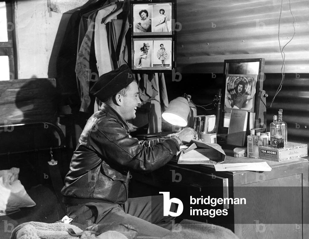 American Eighth Army Air Force troops in England American air crew member Lieutenant Daniels wrapping up a parcel to be sent home to his girlfriend back in the United States, 21st March 1944 (b/w photo)