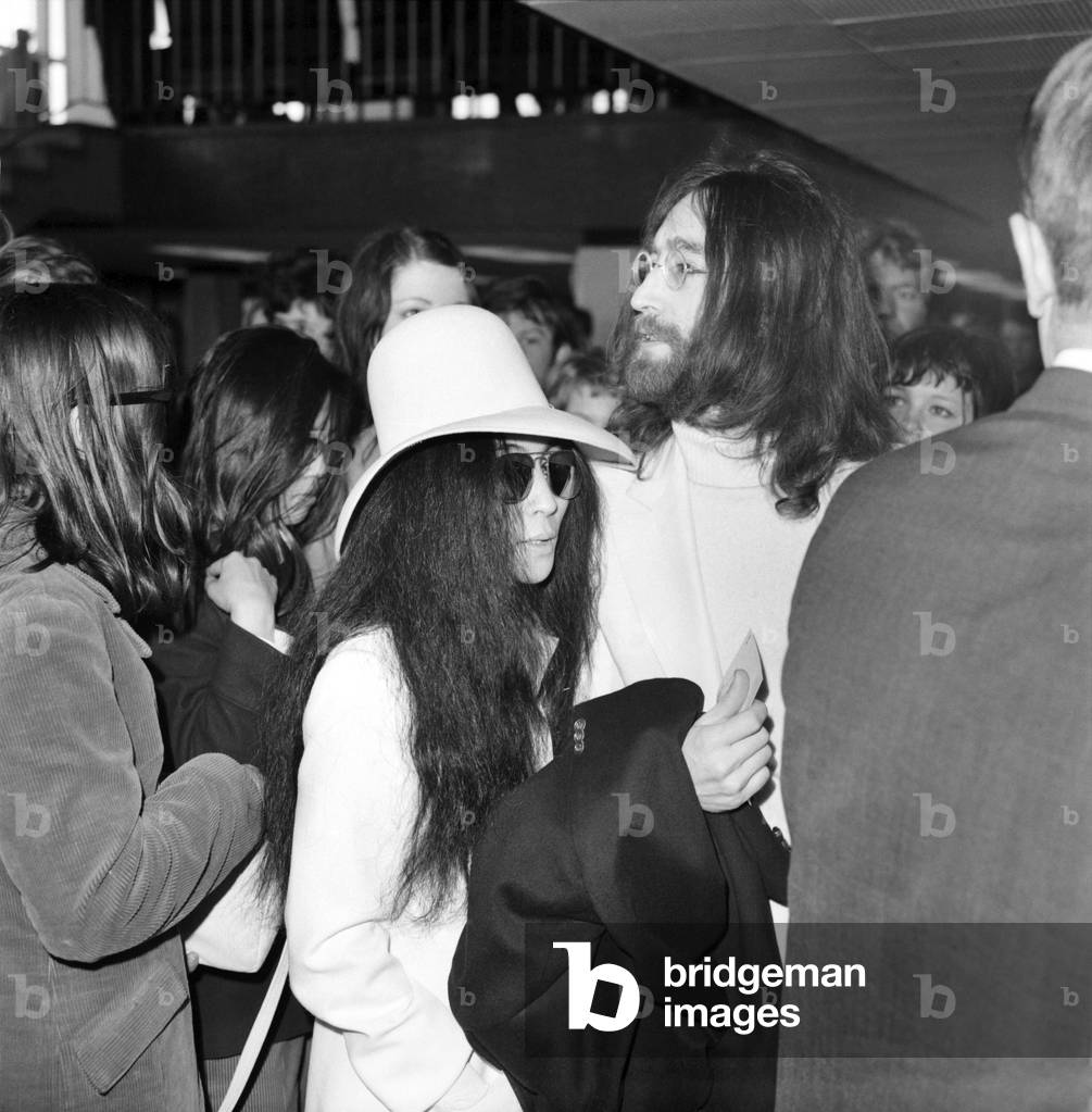 Beatles singer songwriter John Lennon and wife Yoko Ono pictured at Heathrow today. April 1969 (b/w photo)