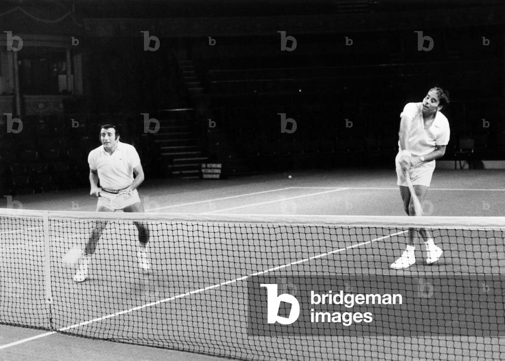 Singer Tony Bennett (left) partners tennis star Pancho Gonzales in a knock-up at the Albert Hall. February 1972 (b/w photo)