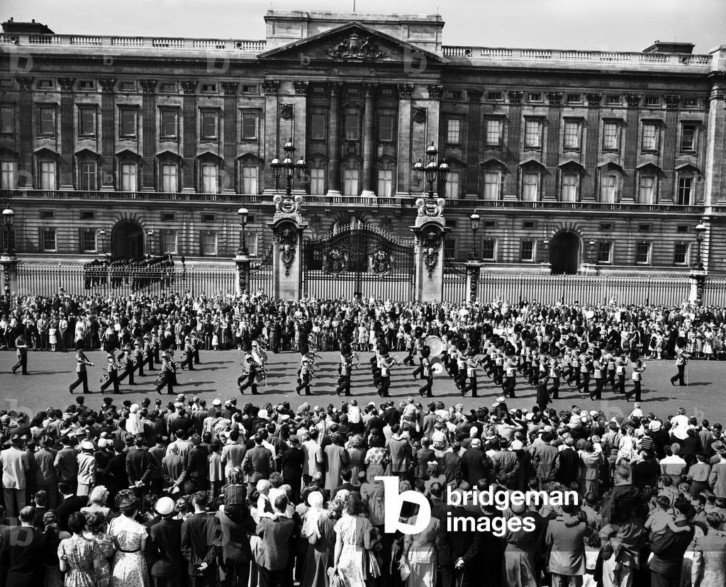 Eight days before Coronation Day, on the Whit Monday bank holiday. Changing the Guard at Buckingham Palace, London. 25th May 1953 (b/w photo)