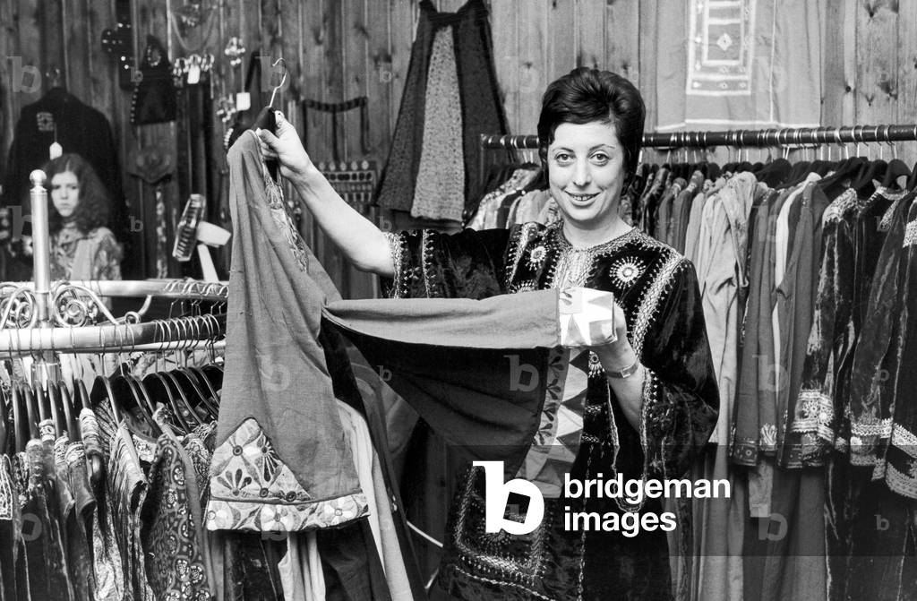 Betty Van Gelder, owner of a dress shop in Hampstead, wearing one of her own velvet shirts which like all the other clothes comes from Hampstead Bazaar, 4th October 1970 (b/w photo)