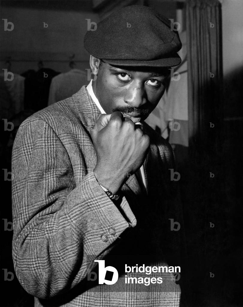American boxer Randy Sandy poses with a clenched fist during his visit to Britain for an upcoming middleweight fight, c.1960 (b/w photo)