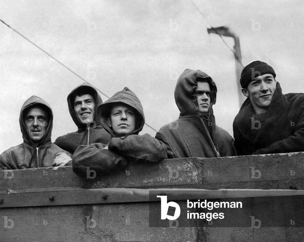 Heroes of the Arctic. Typical members of a ships crew who have fought their way through the ice to convey war supplies to Russia. Left to Right: Bob Kirby, Leo Chartrand, Romeo Lacroix, Bill Mazaruk and Silver Pellerin. February 1942 P012337