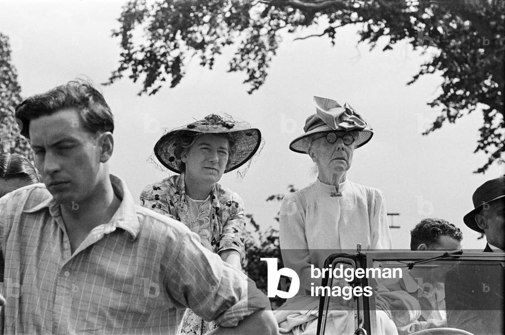 Two women watching an event during Canterbury Week, Kent, August 1947 (b/w photo)