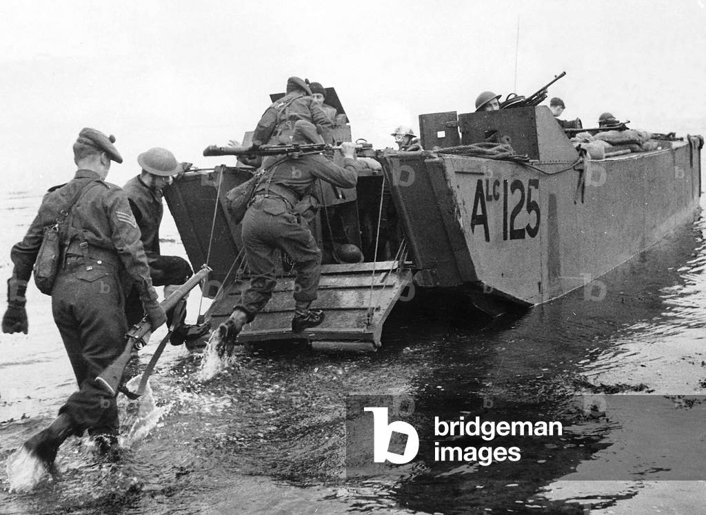 Troops head for home after a combined operation by Navy, Army and Royal Air Force to destroy an important German radio post at Bruneva, twelve miles north of Le Havre, France, 1942 (b/w photo)