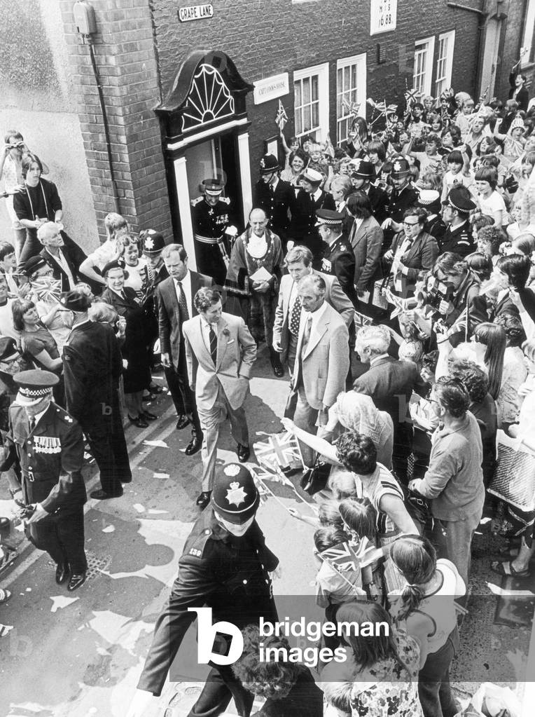 Prince Charles (Future Charles III) is greeted by crowds after visiting Captain Cook's house in Grape Lane, Whitby, 1978 (b/w photo)