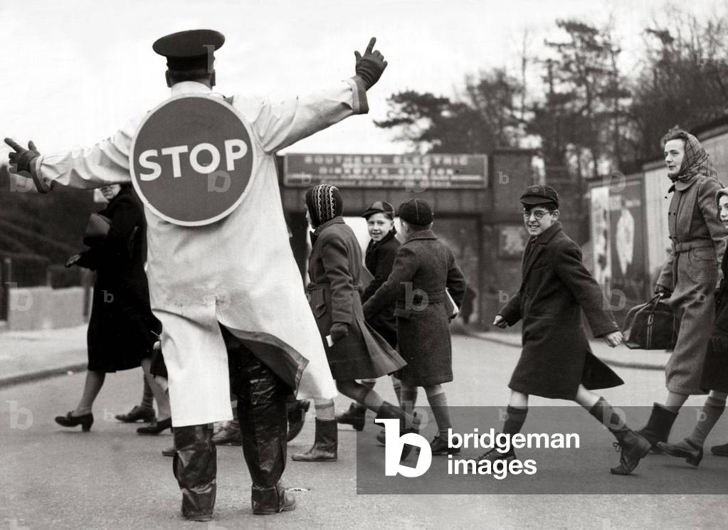 School Crossing Patrol with Free Hands No lollipop stick - STOP sign is stuch to the back of the crossing supervisor. April 1952