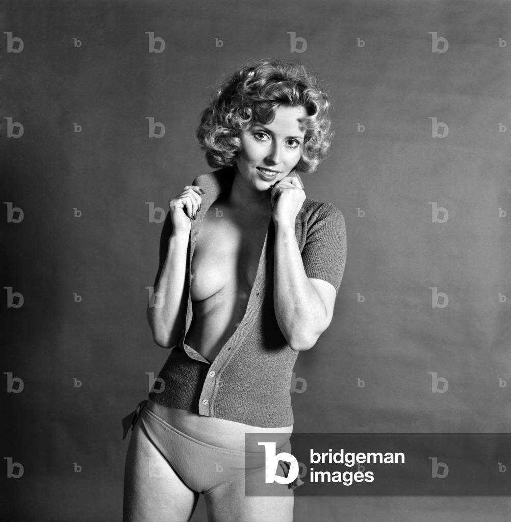 Glamour Model Maiken wearing an unbuttoned top, April 1975 (b/w photo)