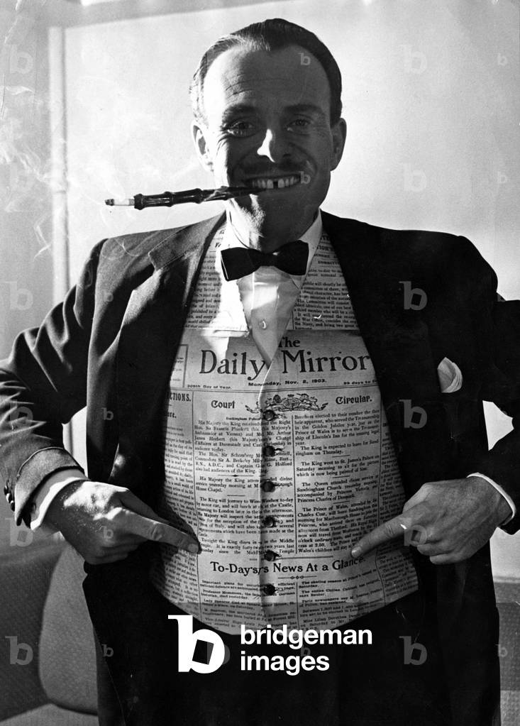 Terry Thomas wearing a waiscoat made from a Daily Mirror, 6/11/1953 (b/w photo)
