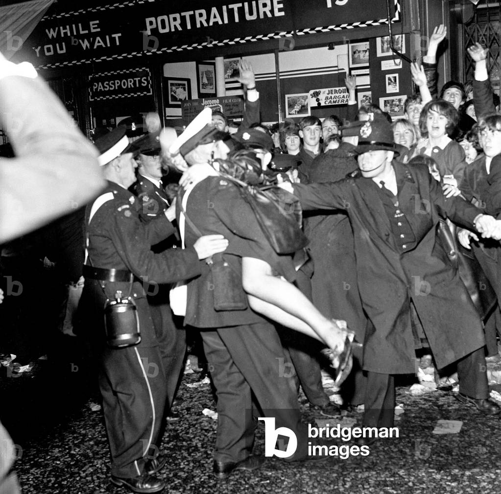 Police try to control fans in the streets of Liverpool before the premiere of The Beatles film 