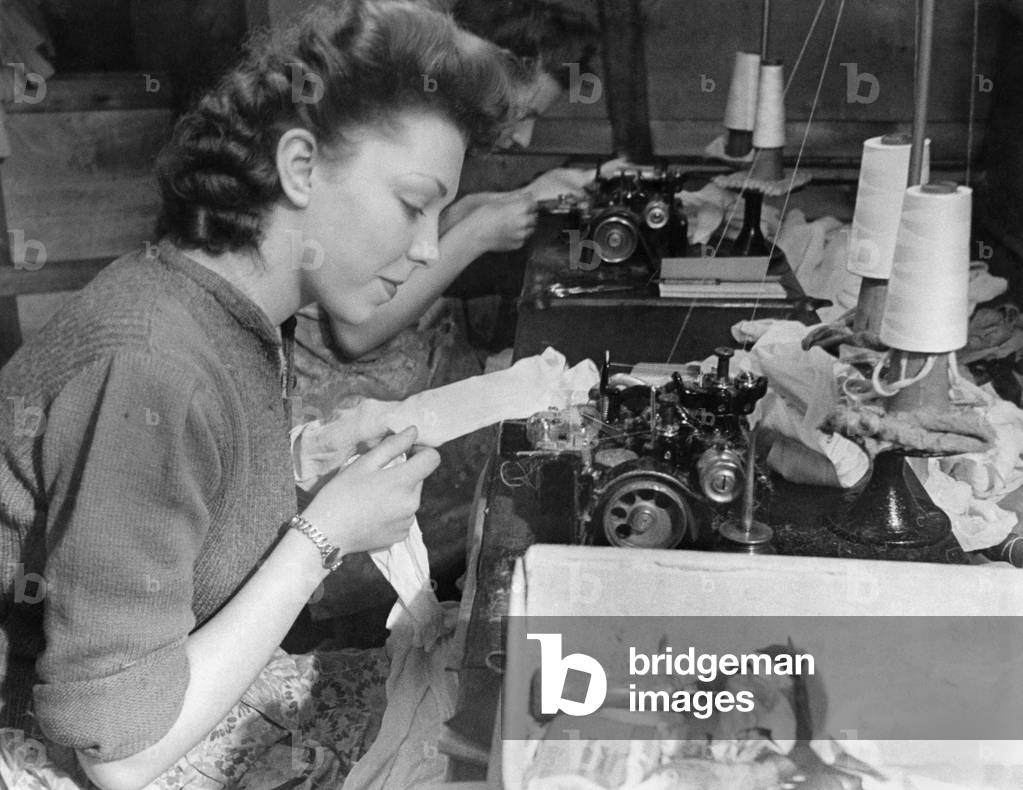 Clothing Stockings. This girl puts seams in stockings at the rate of 4,000 stitches a minute. March 1944 P018457