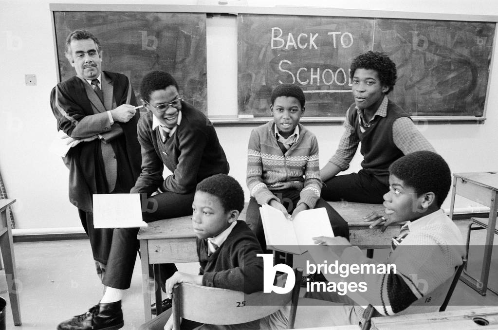 Musical Youth, British Jamaican pop / reggae group, return to school, Duddeston Manor School, and are greeted by deputy headmaster John Cook 2nd November 1983 (b/w photo)