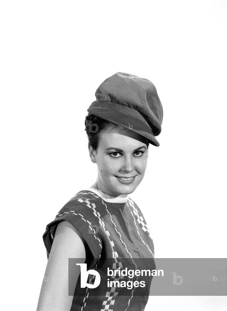 Model Jackie White wearing red coduroy hat, c. 1963 (b/w photo)