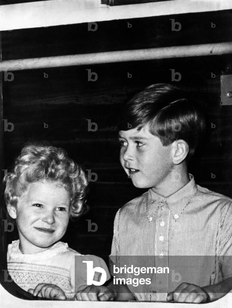 Prince Charles - The Prince of Wales with his sister Princess Anne at the door of a railway train in Aberdeen station, c. 1950
