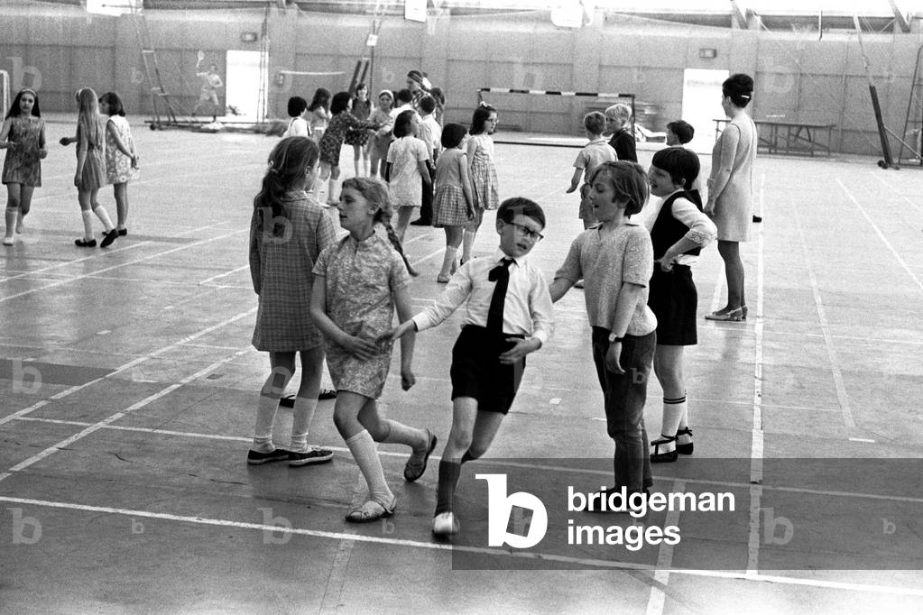 School children take part in an end of school year dance at the Lightfoot Stadium in Walker organised by the English Folk Dance Society 3 June 1970 (b/w photo)