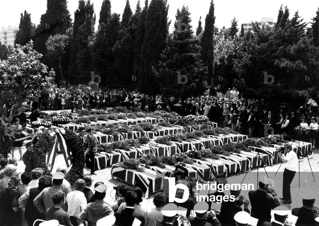 Union Jacks Drape the coffins of forty-five British tourists who died ten days ago when their holiday aircraft crashed in Yugoslavia. Relatives of the victims were flown from England for the open-air service on the Island of Krk. Seventy-two of the seventy-eight victims who died on the Yugotours charter holiday were British. The remaining Britons will be flown back to England for burial. 
June 1971
