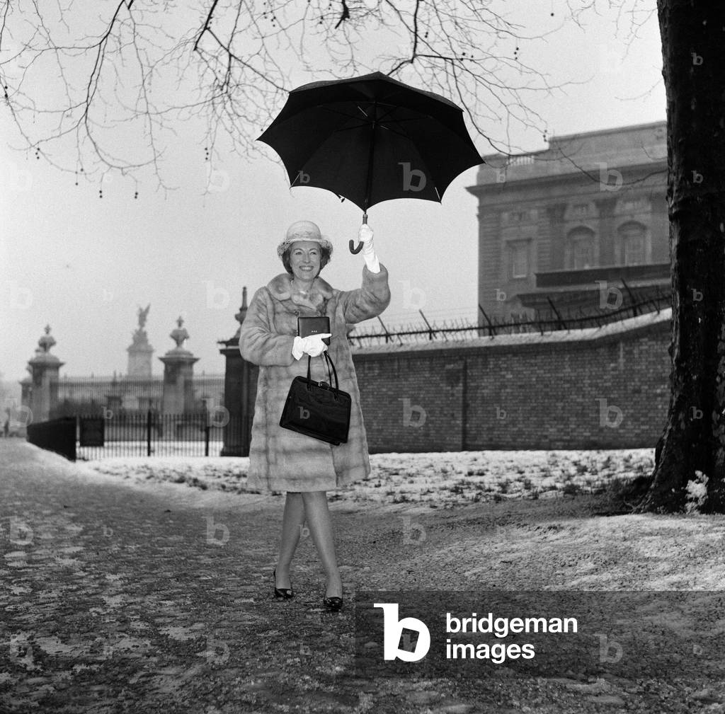 Investitures at Buckingham Palace. Vera Lynn leaves carrying her O.B.E. 11th February 1969 (b/w photo)