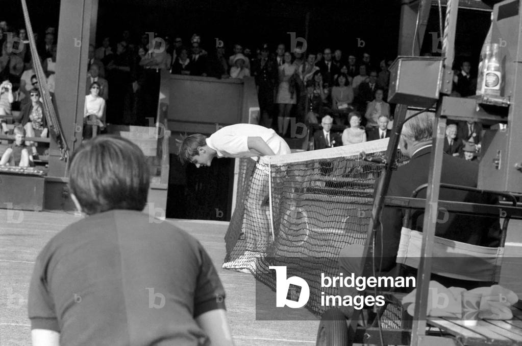 Wimbledon Tennis Championships 1970 1st Day. B. Fairlie almost goes over net trying to reach shot by Roger Taylor. June 1970