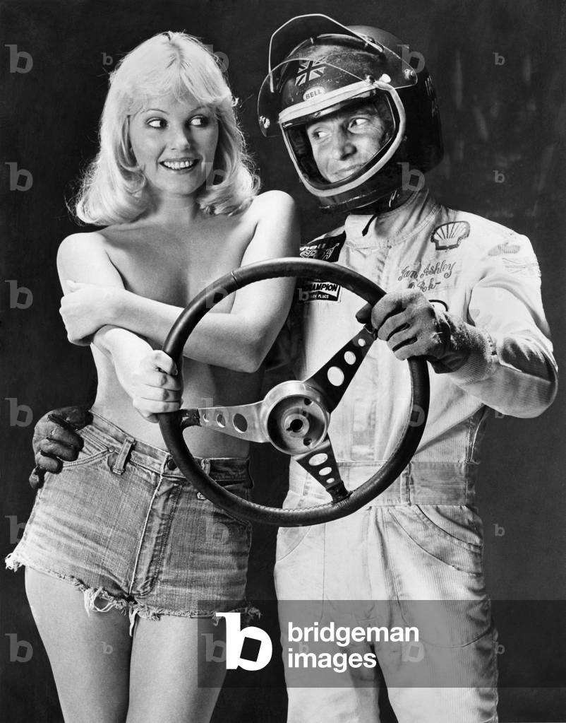 Ian Ashley and Angela Jay pose together holding a steering wheel.