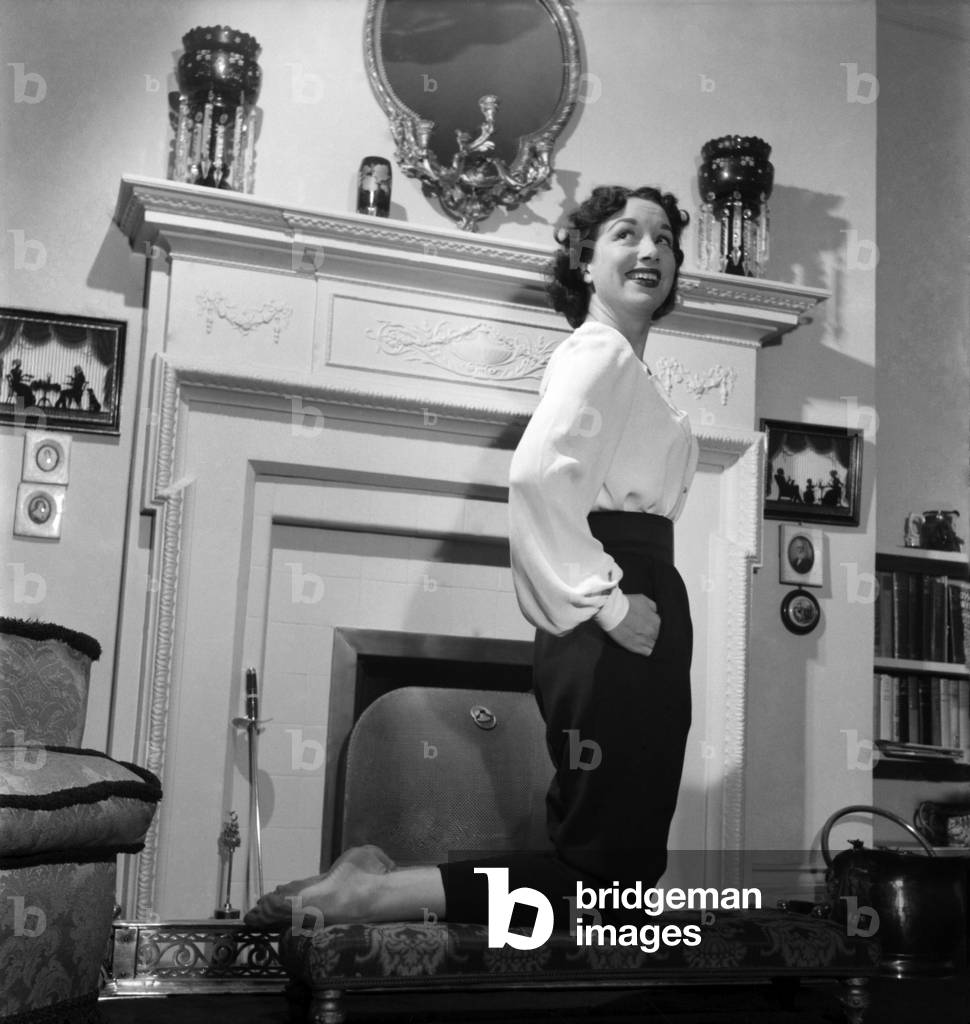After Britain's stage union equity had refused Yoland Dolan a permit for her to play in Peter Pan, a search was made for a British actress who could take the part of Peter. Manchester born Pat Kirkwood who is well known to music hall goers, has been chosen to play the part. These pictures were taken at her Baker Street flat, November 1953