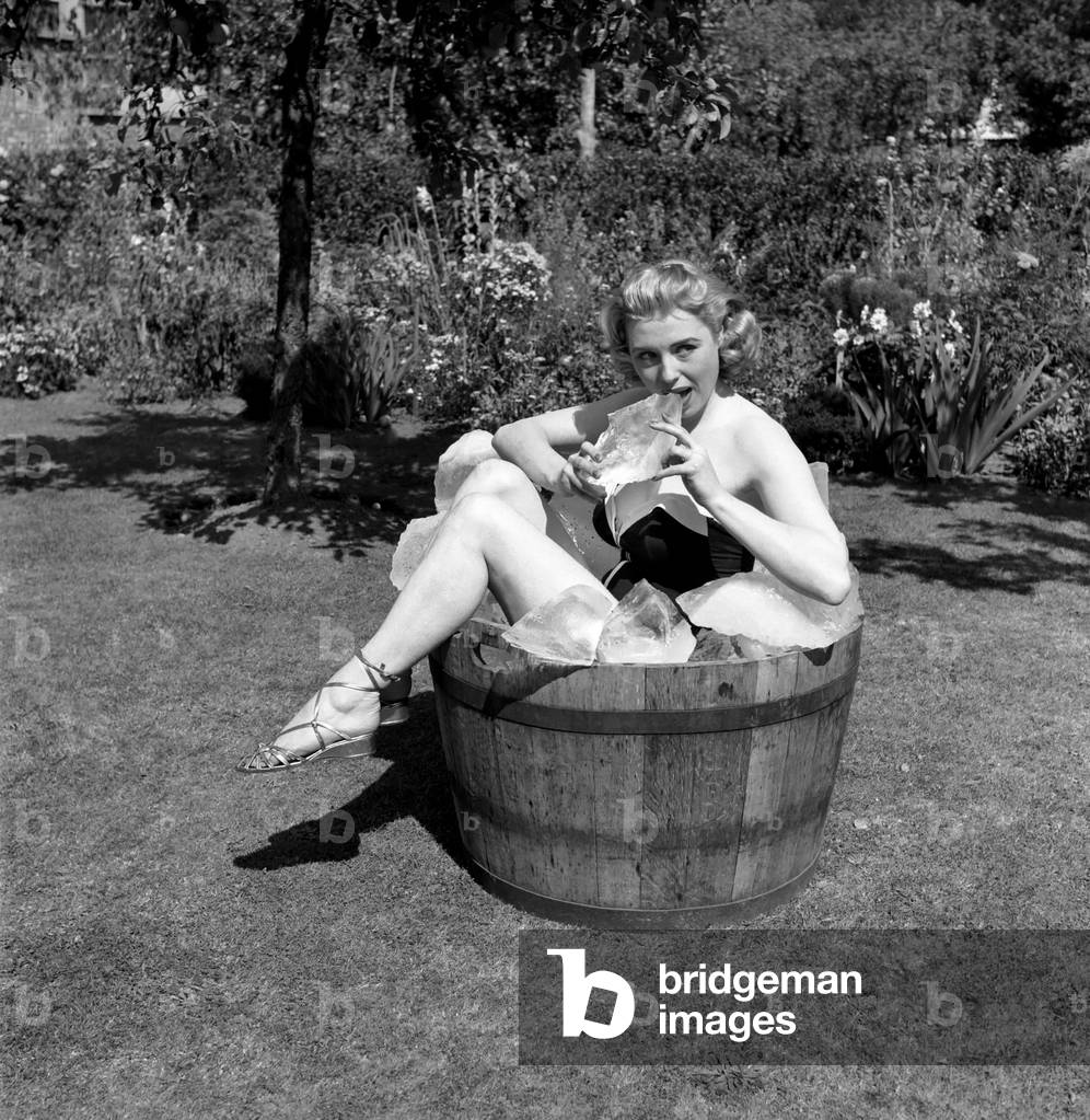 Weather Hot: (Nice girl Sandra). Sandra Dorne has found an arctic region method of keeping cool while shooting her latest film 