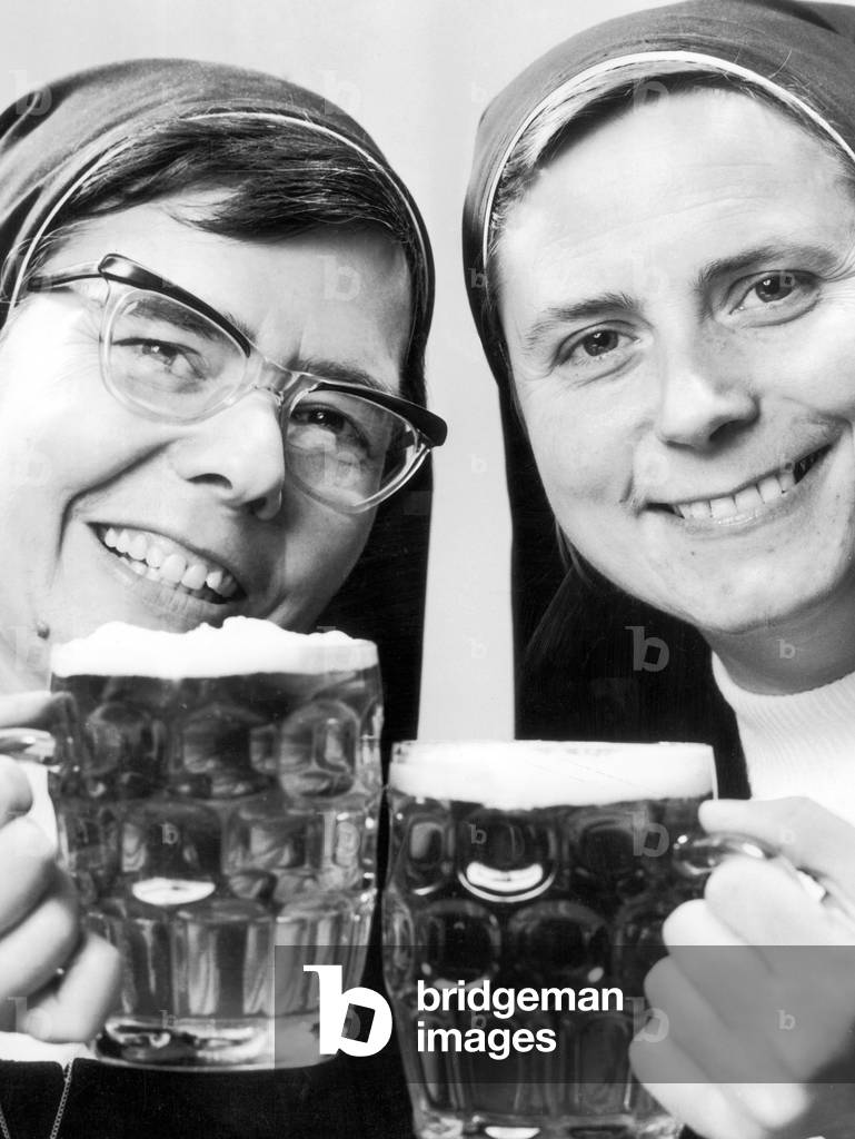 Sister Elizabeth and Sister Joan had a confession to make. They have finally hit the bottle, since arriving in Scotland several year ago, they have not had a sip of beer. But broke the rule of a life time and sampled two big frothing pints. 12th November 1970 (b/w photo)