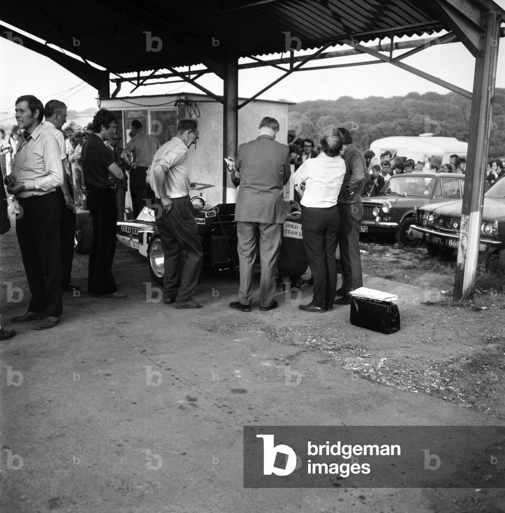 Brands hatch British Grand Prix. British Grand Prix winner Jochen Rindt (left) watches the official Stewards examining his car after the race. July 1970