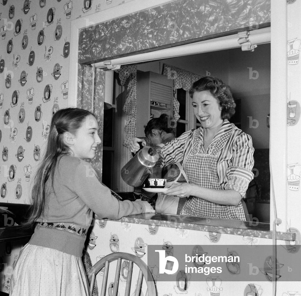 Housewife Vera Lynn at home with her daughter Virginia. 17th March 1957 (b/w photo)