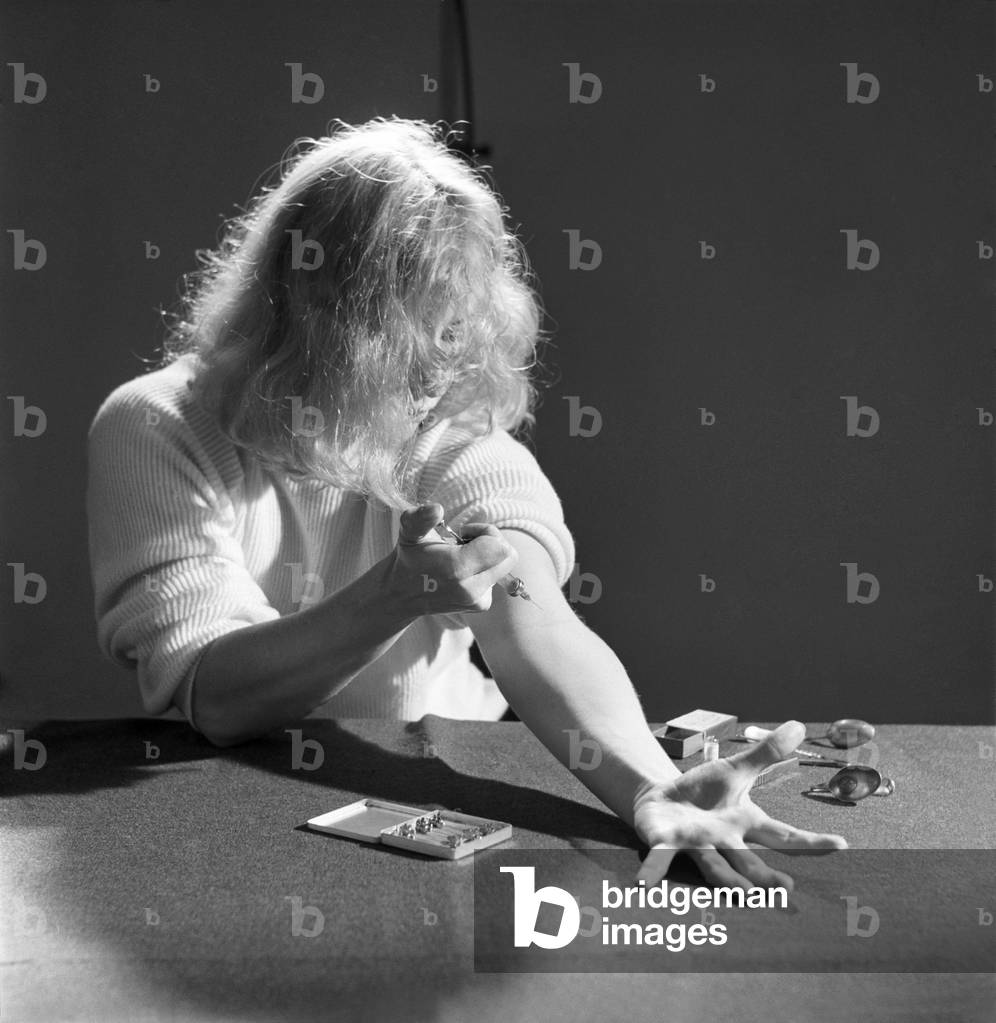 Model shot: Drug addict seen here taking drugs. 1960