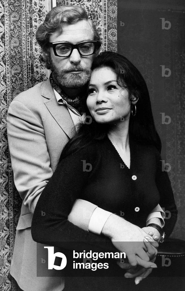Michael Caine with his arms around girlfriend Minda November 1969 (b/w photo)