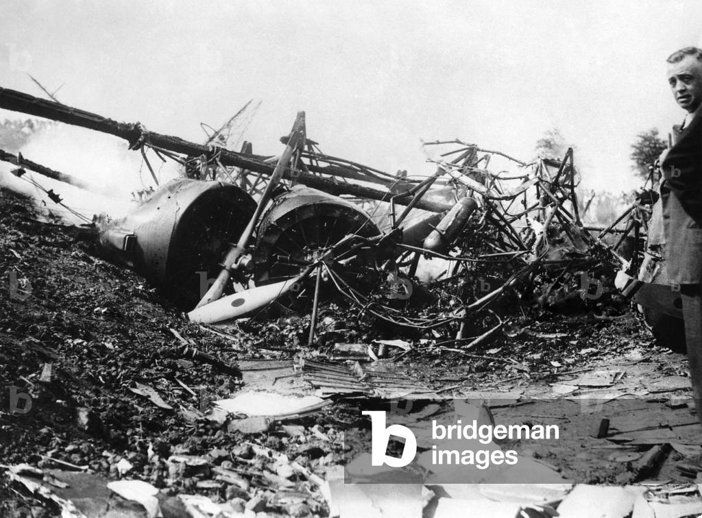 Dutch Air Liner Crash. Six people, two of them Englishmen, were killed and three seriously injured, when a Dutch air liner, carrying twenty persons, crashed and burst into flames at Schephol Aerodrome, Amsterdam. Photo Shows. The remains of the air liner still smouldering showing the engines. July 1935