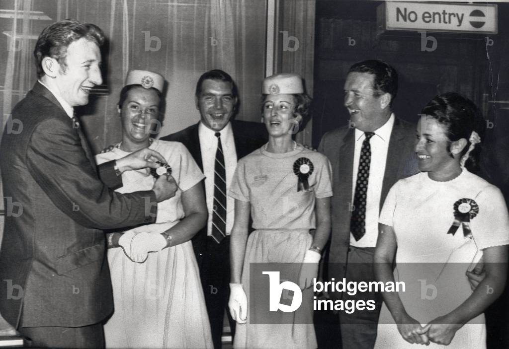 Celtic FC Tommy Gemmell looks pleased as he examines the rosette worn by Susan Ballantyne as team-mate Bobby Murdoch and manager Jock Stein are joined by Air France hostesses Jill Edison and Pat Taylor, July 1969 (photo)