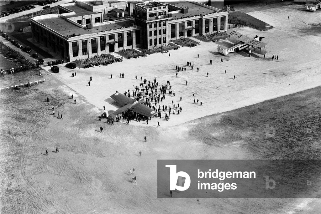 Scene at Croydon as French aviator Louis Bleriot arrives for twenty year commemoration ceremonies in England, after having again flown the Channel in one of his own planes, a Bleriot 127 bomber (pictured centre). Armstrong 27th July 1929 (b/w photo)