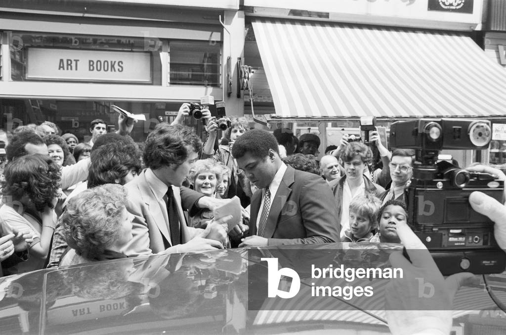Muhammad Ali signing autographs outside the Odeon in Birmingham. 7th June 1979 (b/w photo)