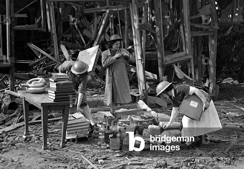 Nurses take a record of the remains in the midst of the bomb damage at London Hospital, July 1944 (b/w photo)